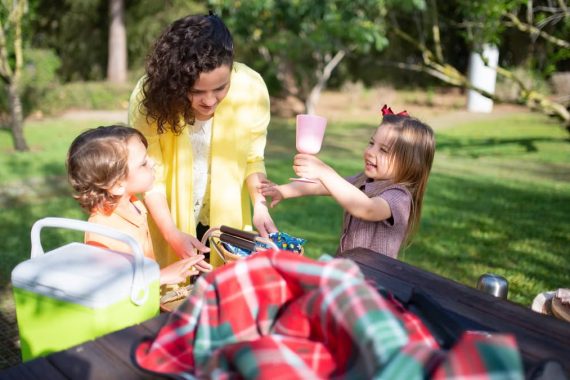 Happy family having a picnic in a sunny park, enjoying quality time together.